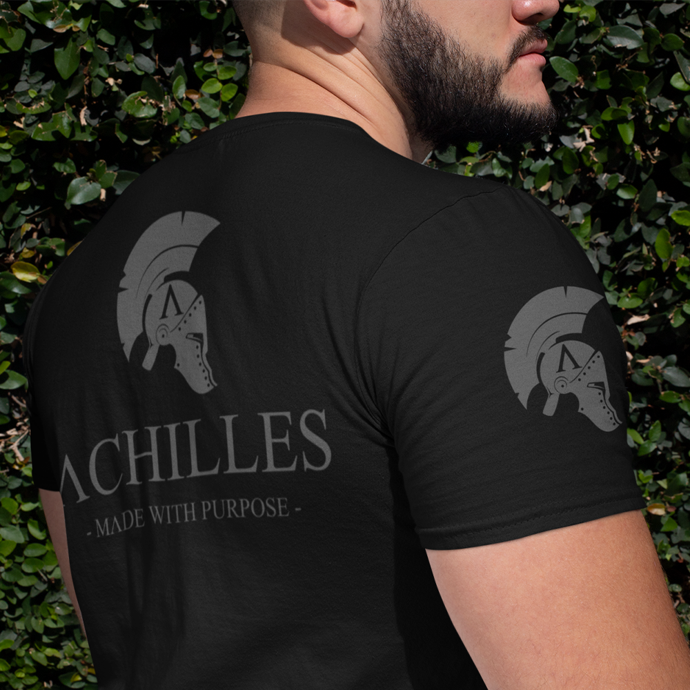 Back view of man wearing Black short sleeve unisex fit classic cotton T-Shirt by Achilles Tactical Clothing Brand printed with Large Signature Branded design across back