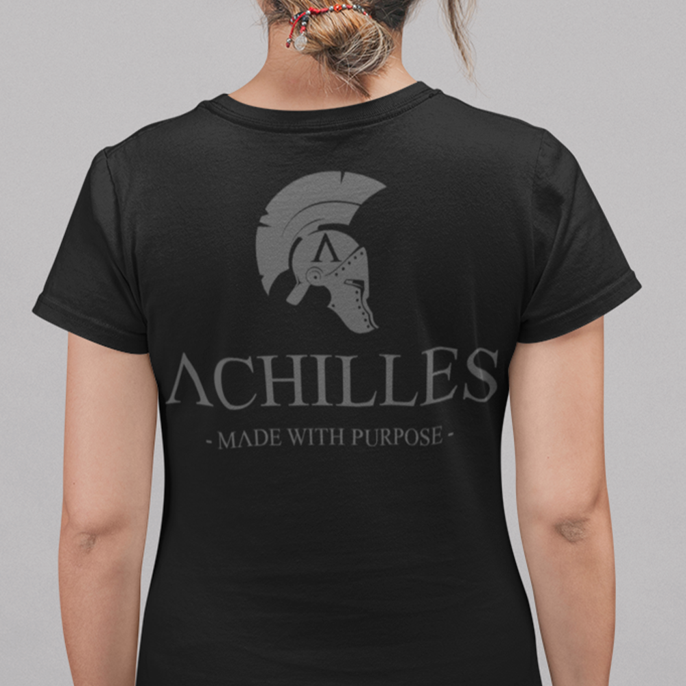 Back view of woman wearing Black short sleeve unisex fit classic cotton T-Shirt by Achilles Tactical Clothing Brand printed with Large Signature Branded design across back