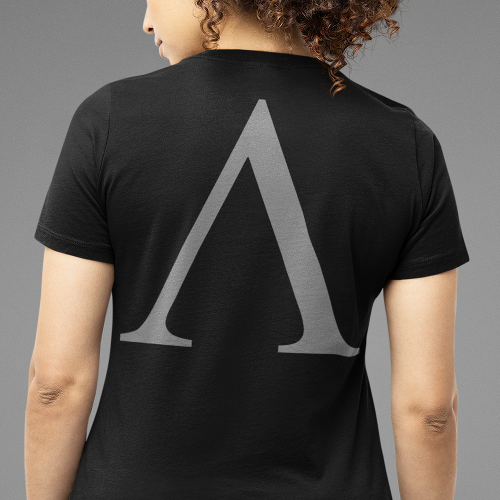 Back view of woman wearing Black short sleeve unisex fit original cotton T-Shirt by Achilles Tactical Clothing Brand printed with Alpha A branded design across back