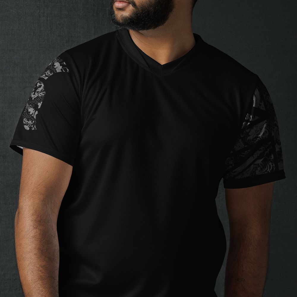 Close up of front of man wearing black Activewear Achilles Tactical Clothing Brand short sleeve unisex T-shirt with helmet and union flag printed in grey Japanese style design