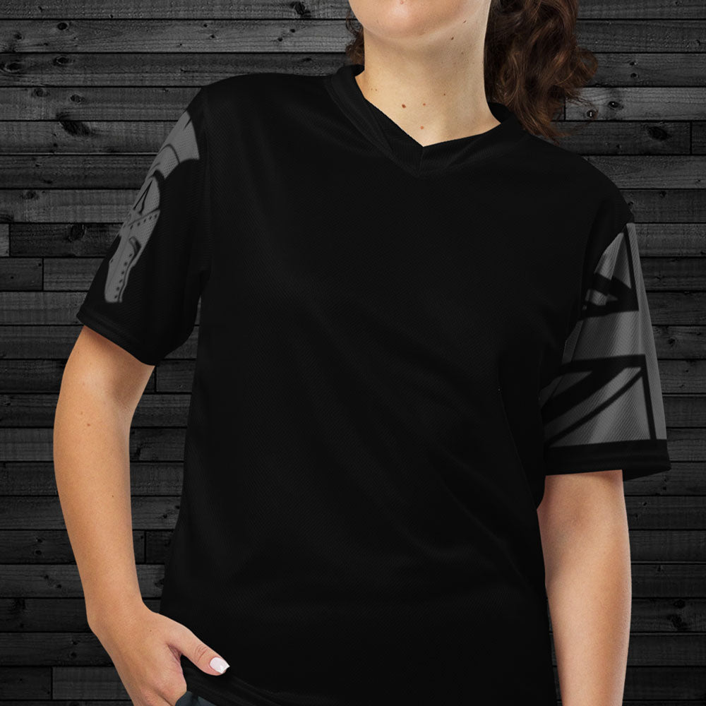 Close up of front of woman wearing black Activewear Achilles Tactical Clothing Brand short sleeve unisex T-shirt with helmet and union flag printed in wolf grey