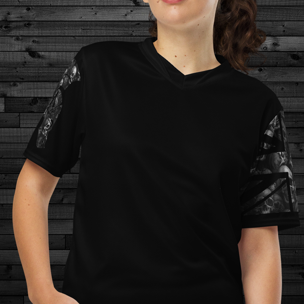 Close up of front of woman wearing black Activewear Achilles Tactical Clothing Brand short sleeve unisex T-shirt with helmet and union flag printed in grey Skulls style design