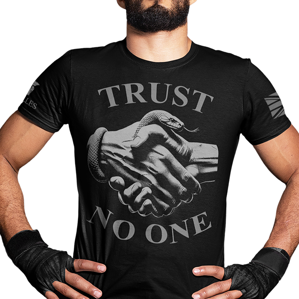 Front view of man wearing Black short sleeve classic cotton unisex fit T-Shirt by Achilles Tactical Clothing Brand with screen printed Trust No One design
