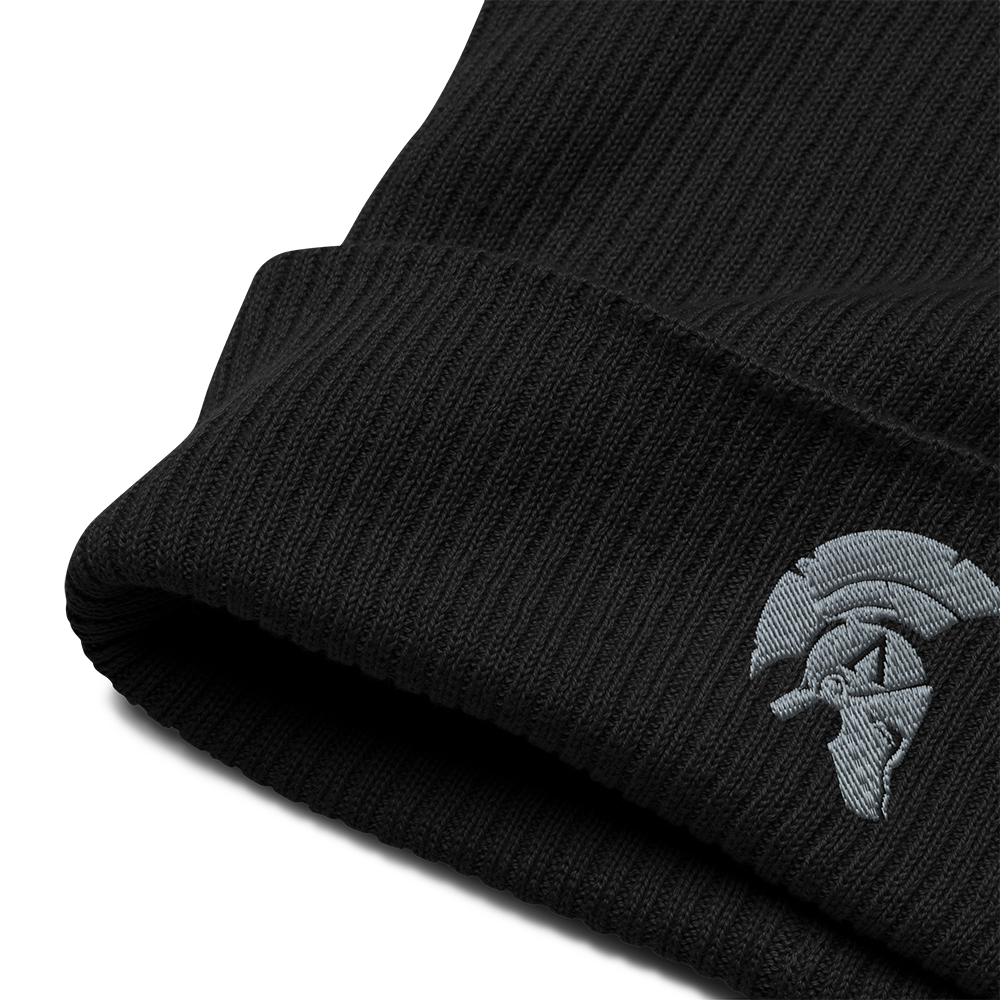 Close Up front view of black cotton organic ribbed beanie with Achilles Tactical Clothing Brand embroidered helmet logo in wolf grey