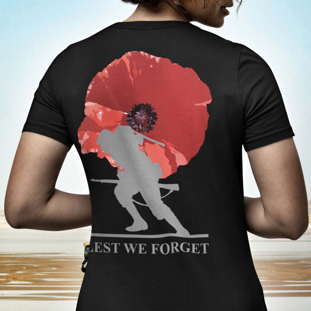 Back view of Woman wearing black short sleeve unisex fit cotton T-Shirt by Achilles Tactical Clothing Brand printed with soldier and poppy lest we forget across the back.