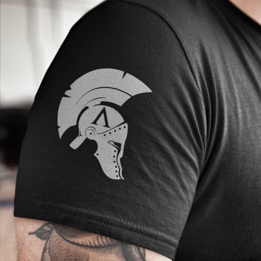 Close up of High definition Achilles helmet logo printed on right sleeve of black cotton short sleeve unisex fit T-Shirt by Achilles Tactical Clothing Brand