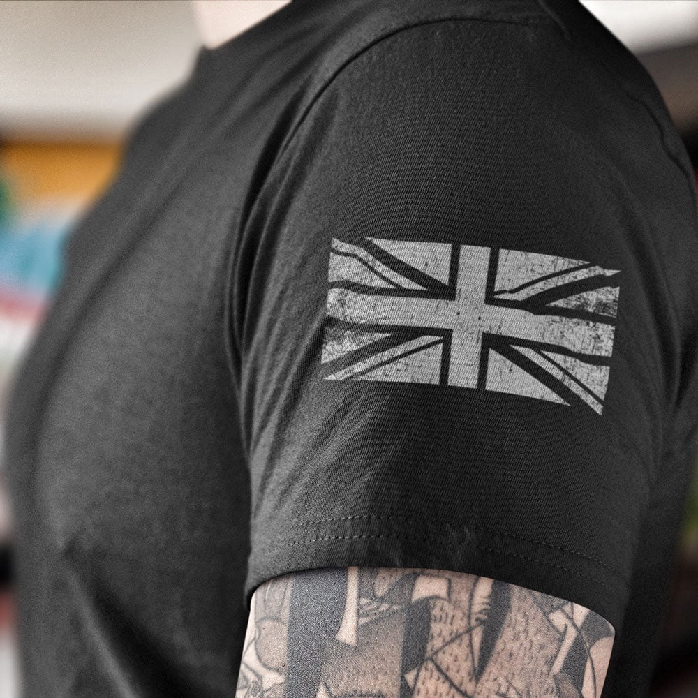 Close up of Distressed grey union flag printed on left sleeve of black cotton short sleeve unisex fit T-Shirt by Achilles Tactical Clothing Brand