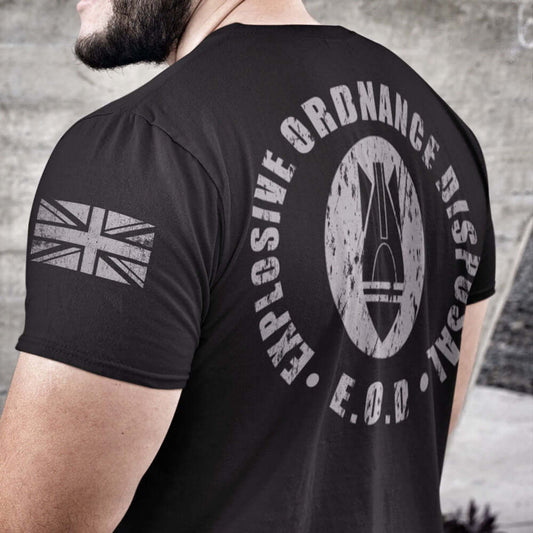 Close up of Man wearing Black short sleeve unisex fit cotton T-Shirt by Achilles Tactical Clothing Brand printed with Large Bomb Logo and Explosive Ordnance Disposal design across the Back