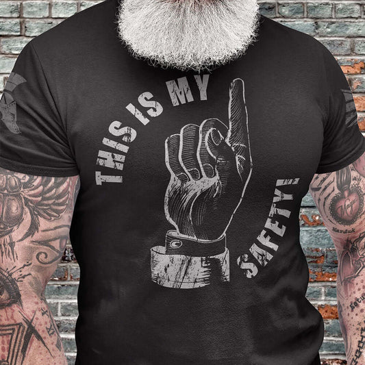 Close up of Man wearing Black short sleeve unisex fit cotton T-Shirt by Achilles Tactical Clothing Brand printed with This Is My Safety and Finger design across the front chest